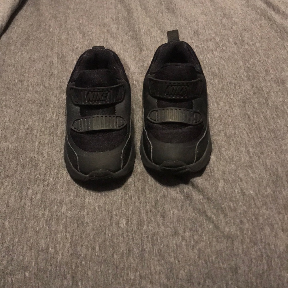 Kids all black Nike sneakers